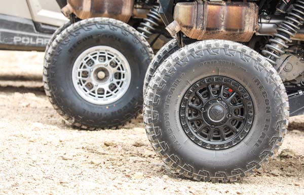 Close-up of a RECON TRAIL ATV and UTV off-road tire sidewall mounted on a side-by-side vehicle.